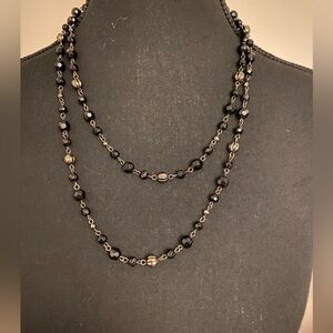 Long black beaded chain.